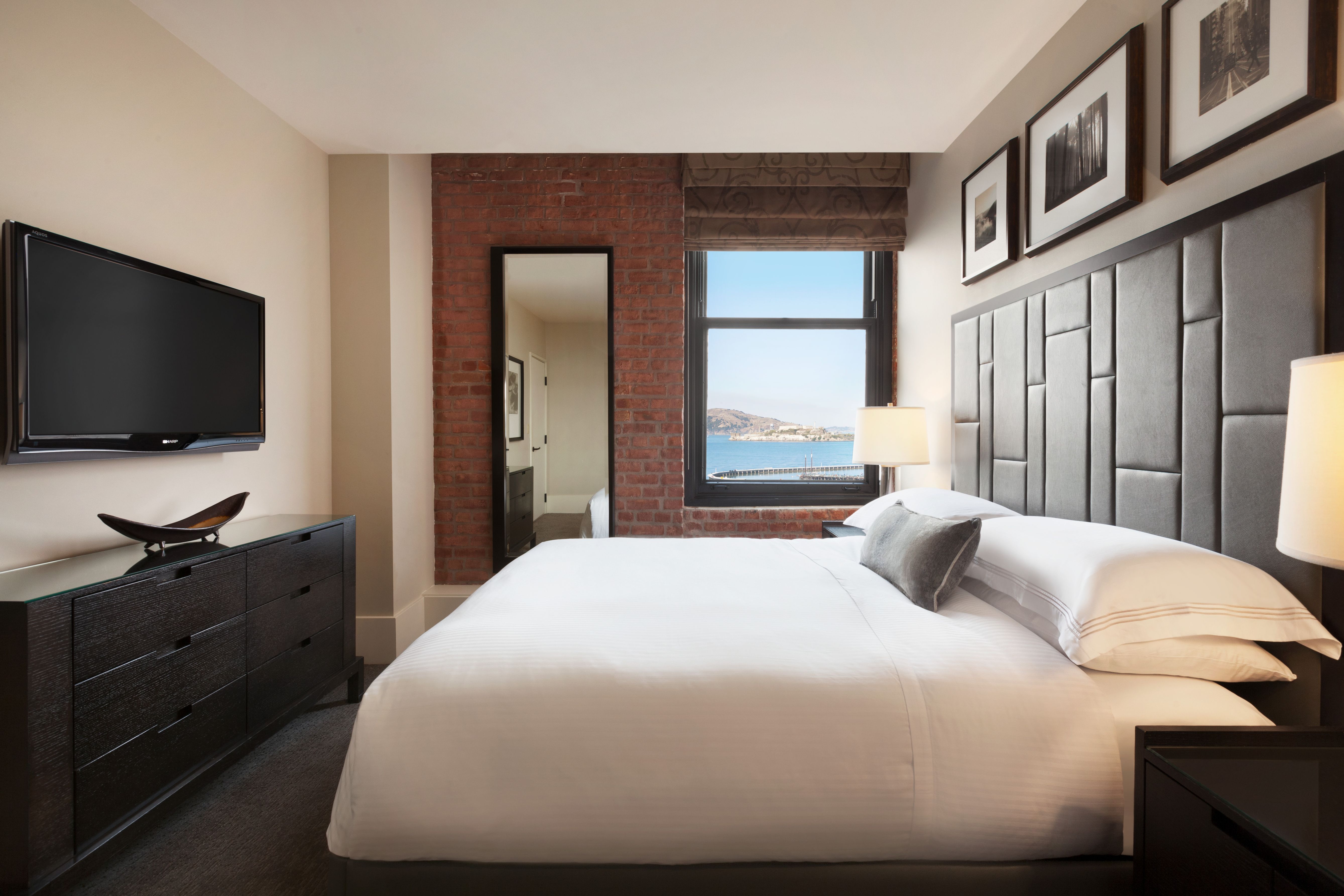 a bedroom with a large bed and a television