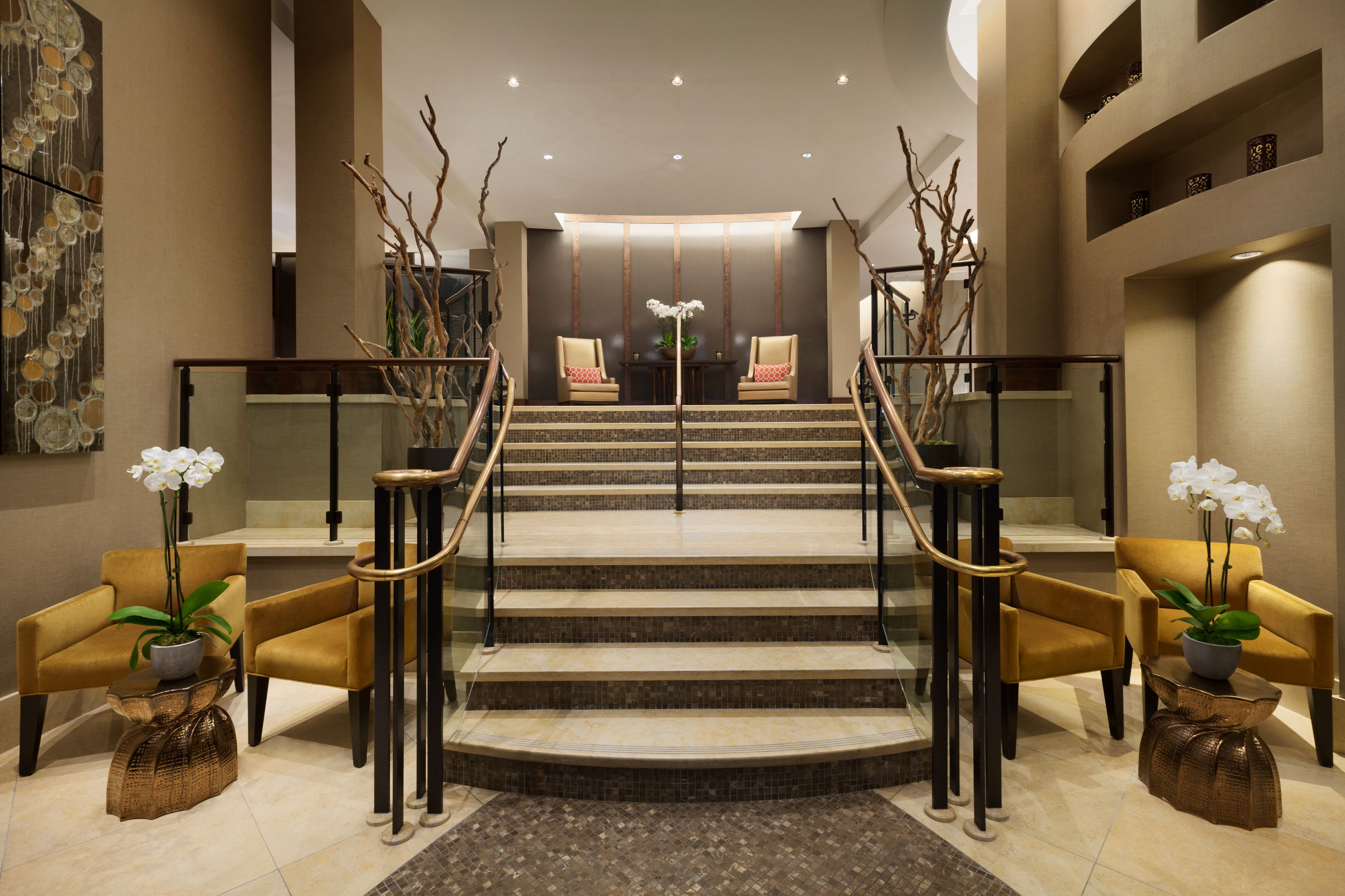 a staircase with chairs and a table