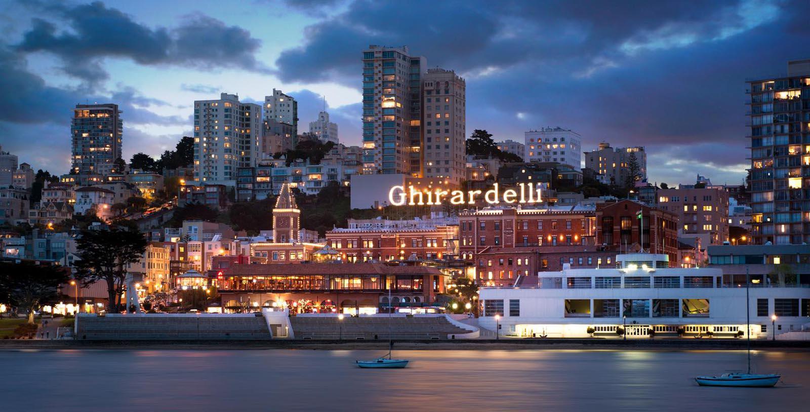 a city with lights on the side of the water