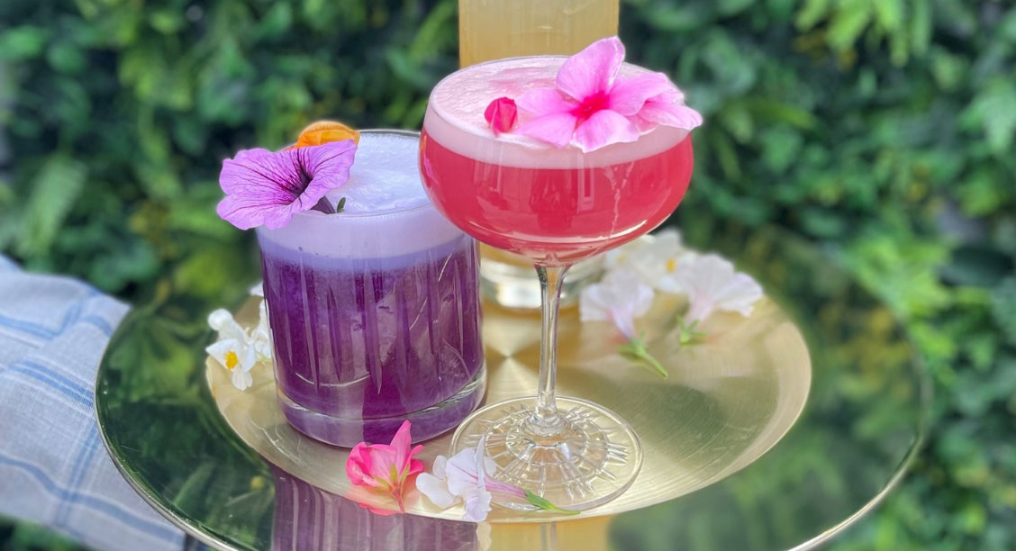 a two glasses with drinks on a tray