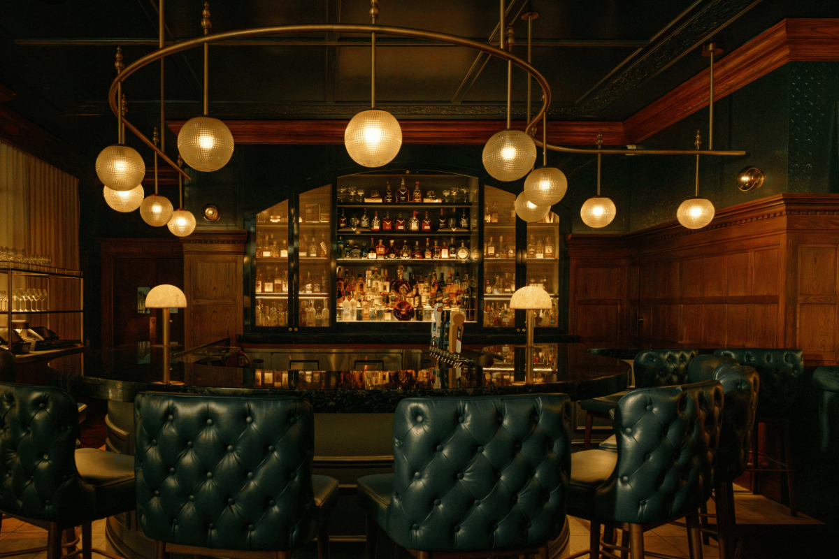 a bar with chairs and lights