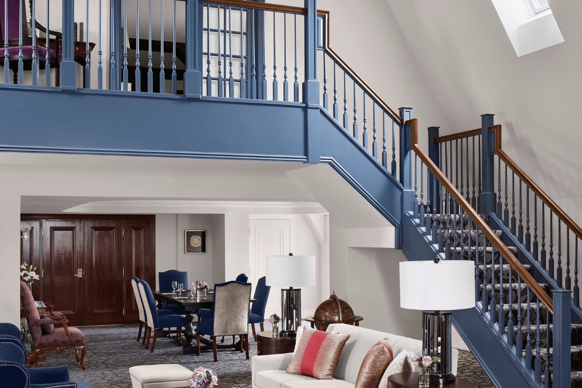 a living room with a blue staircase and a couch