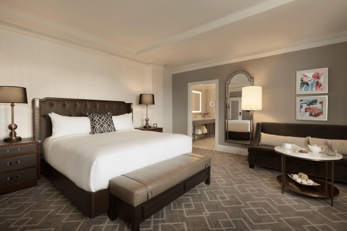 a bedroom with a bed and a mirror