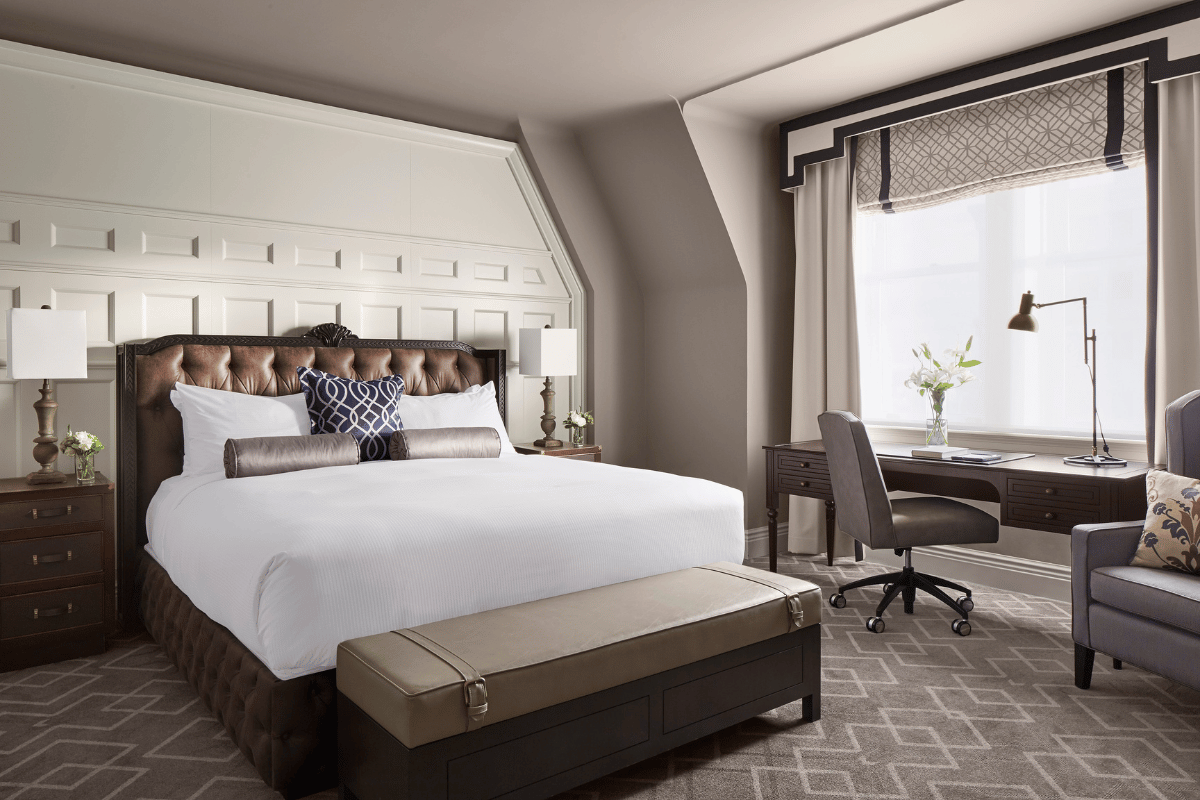 a bedroom with a desk and a bed