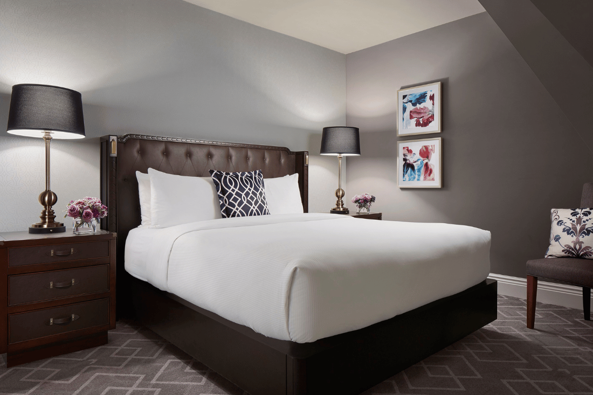 a bed with a lamp and pictures on the wall