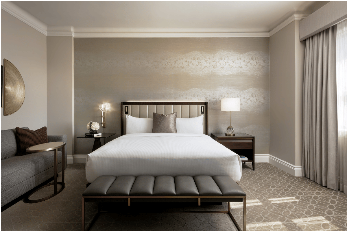 a bedroom with a bed and a bench