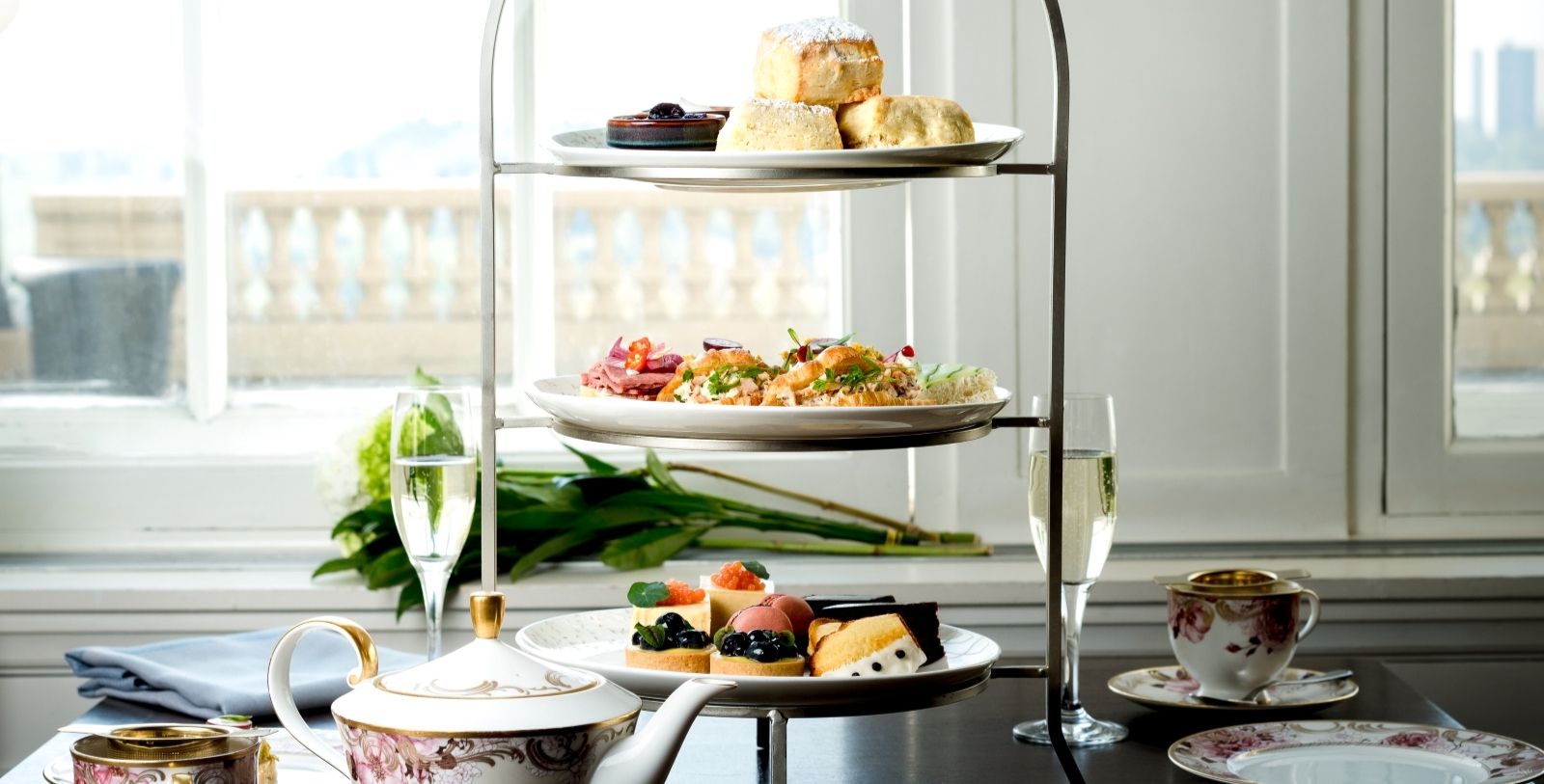 a three tiered tray with food on it