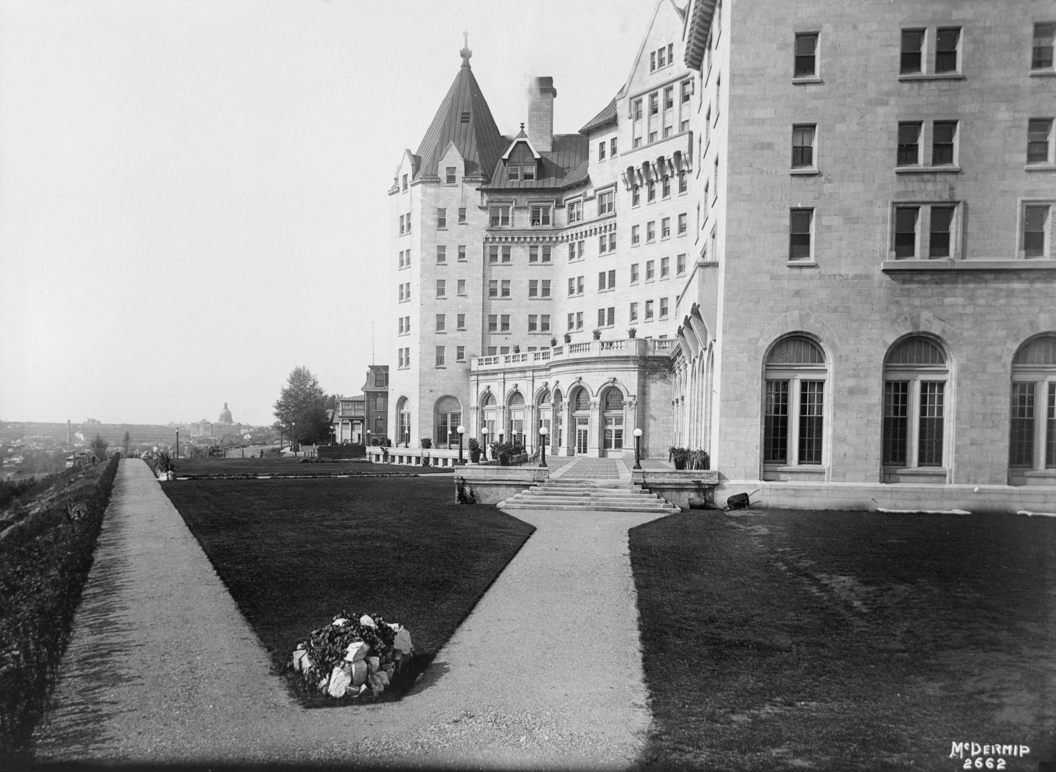 a large building with a lawn and a walkway
