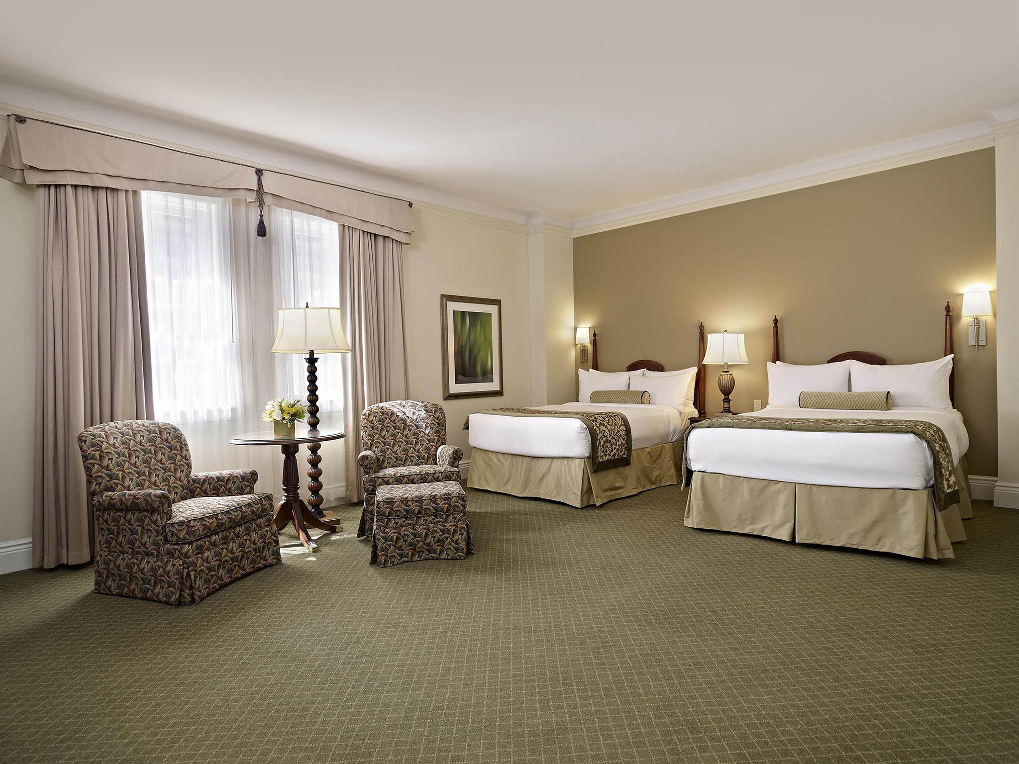 a hotel room with two beds and a table