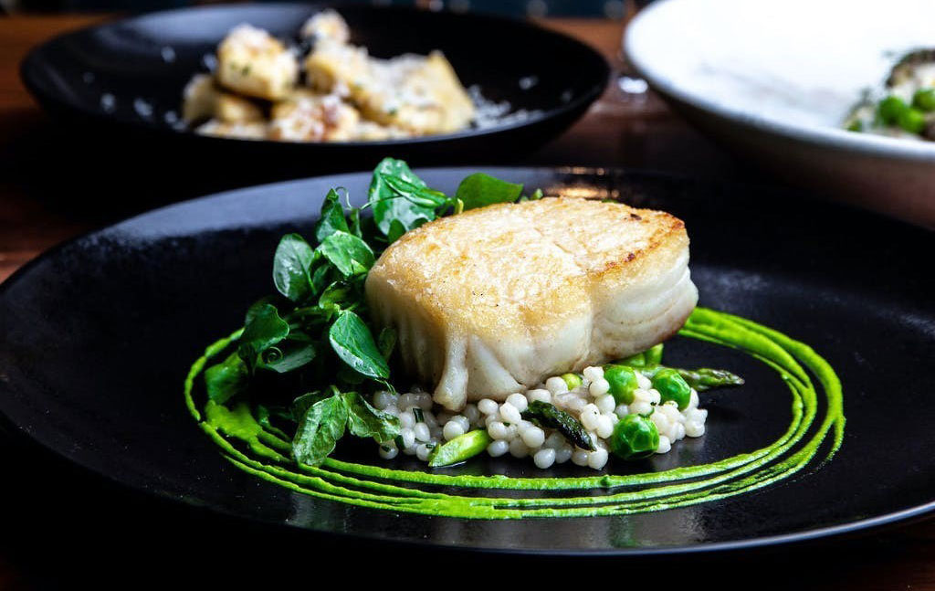 a plate of food on a black plate