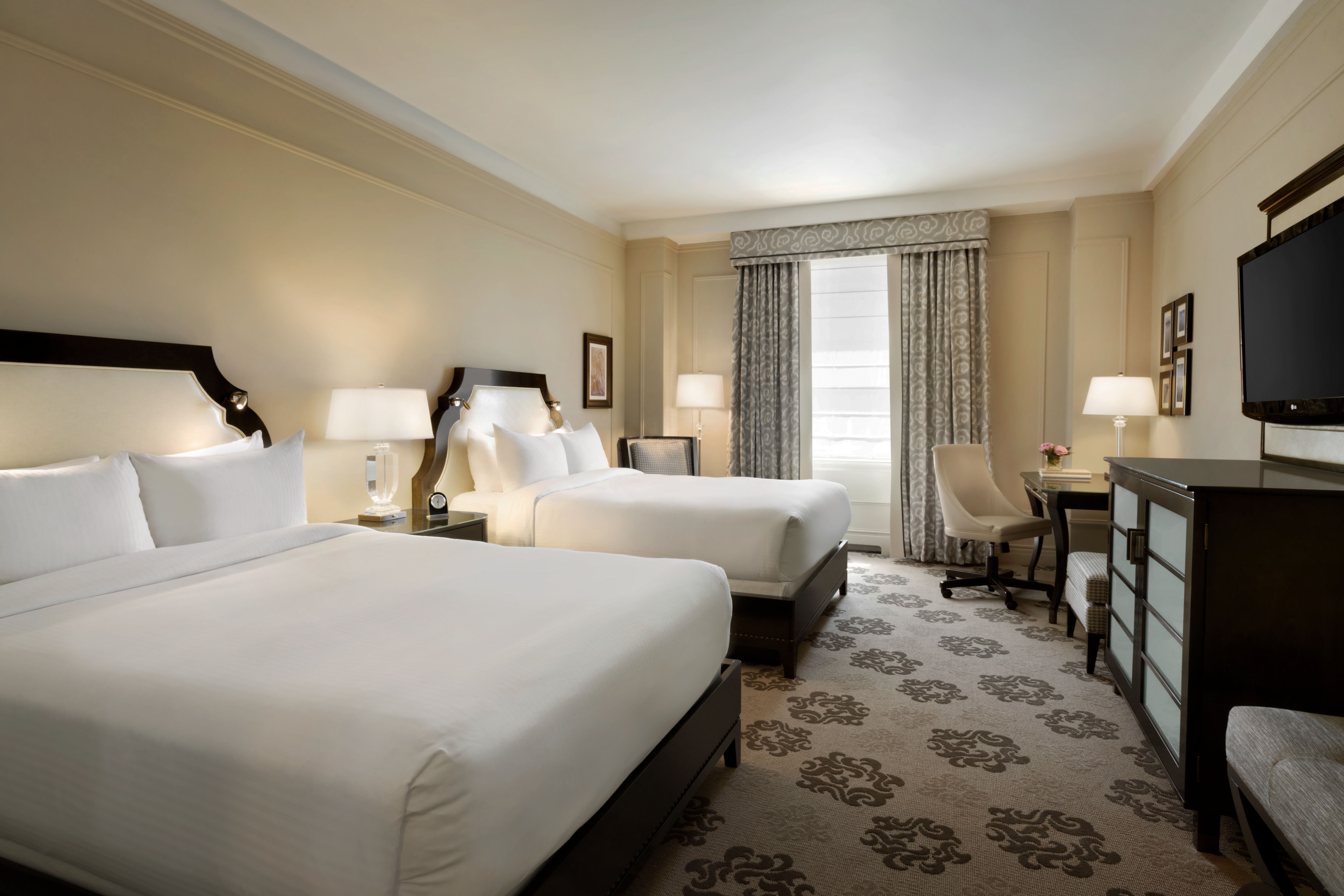 a room with two beds and a table
