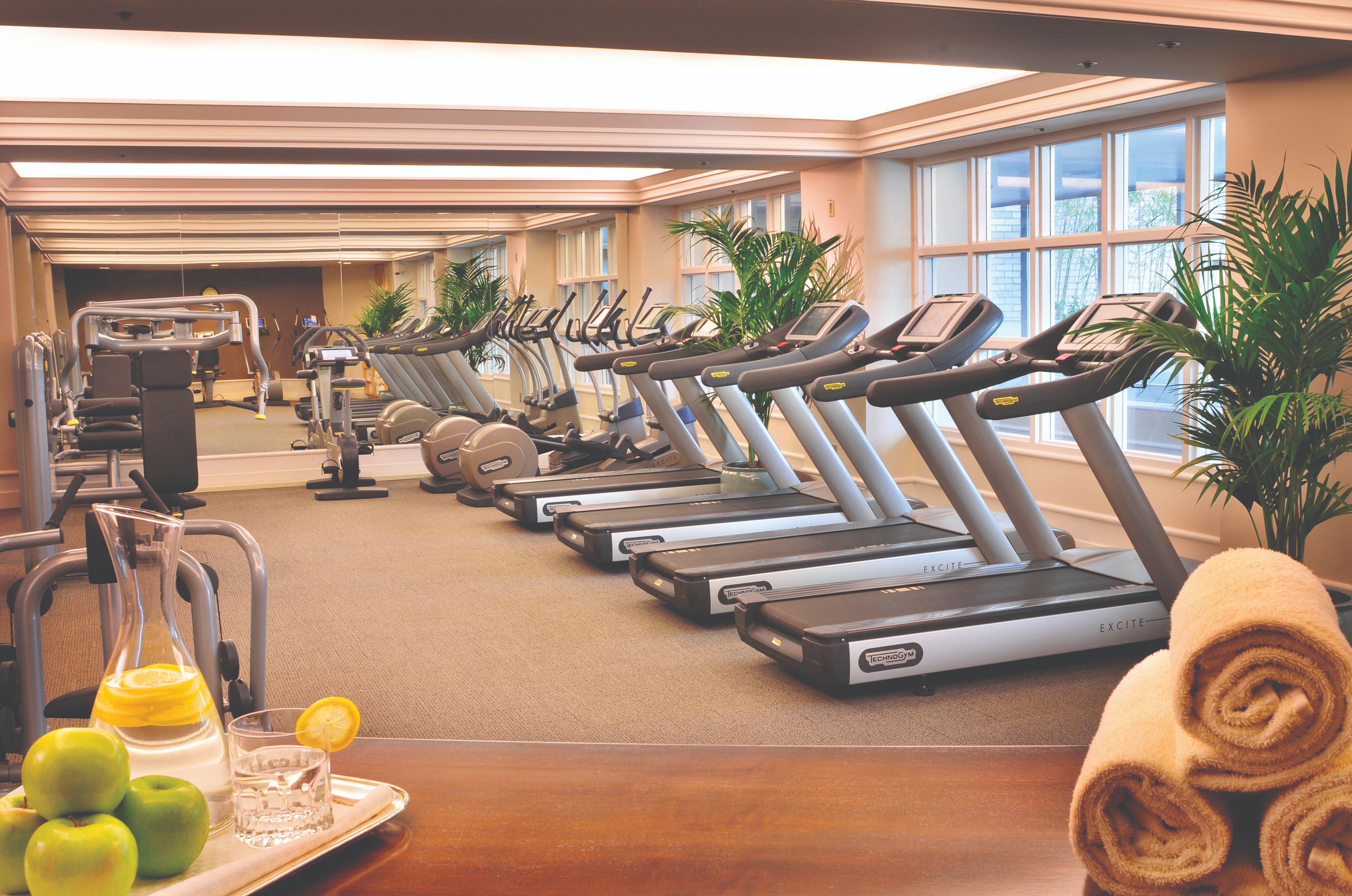a room with treadmills and a glass of lemonade