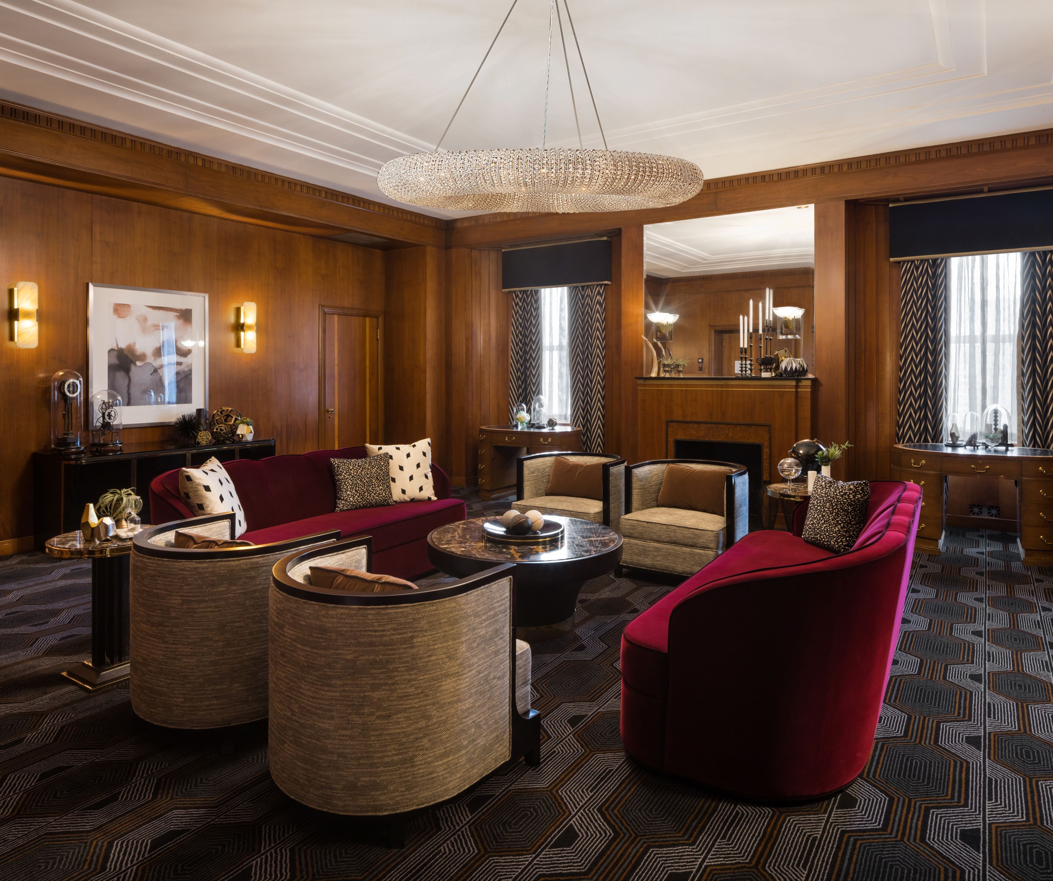 a room with a chandelier and couches