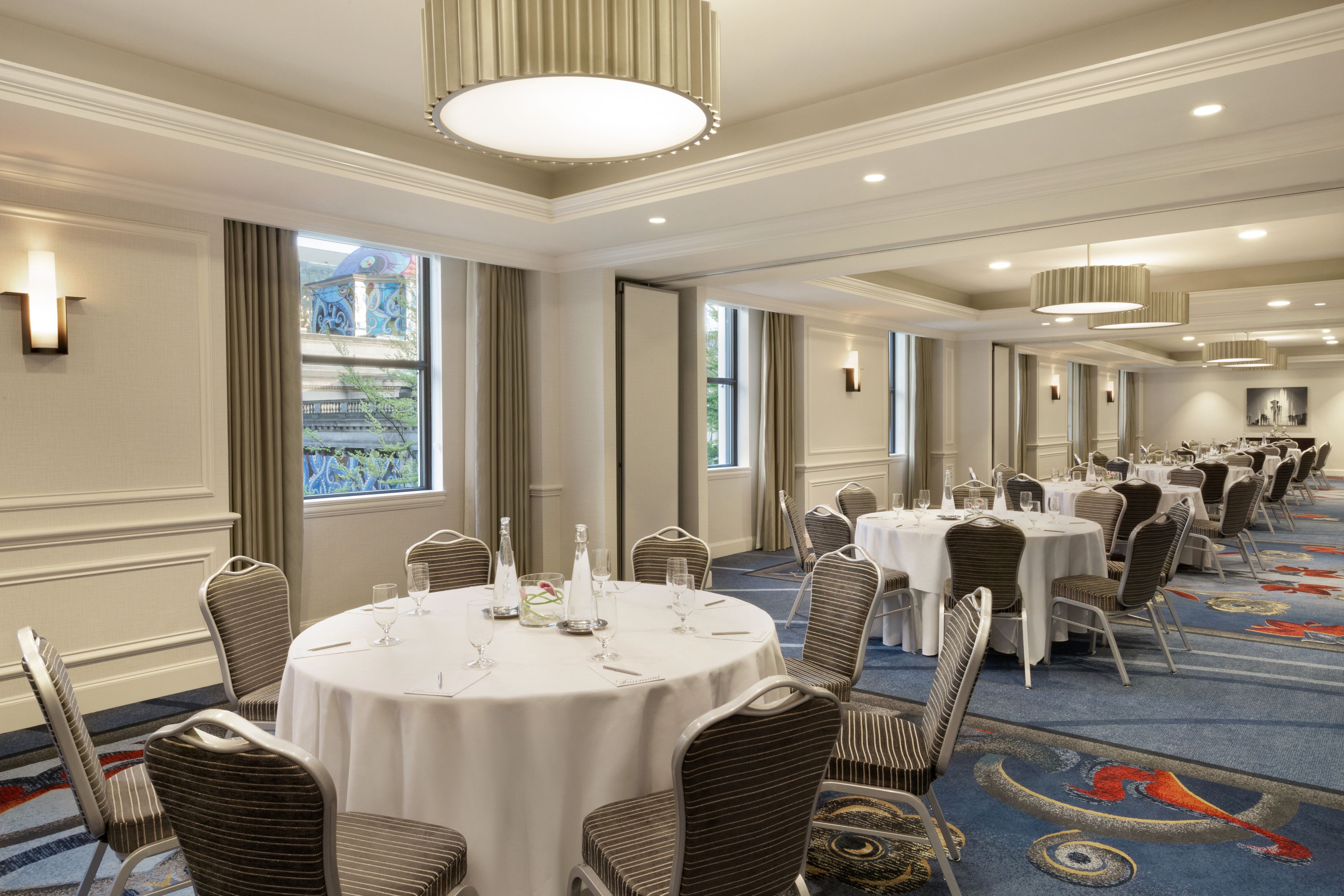 a room with round tables and chairs