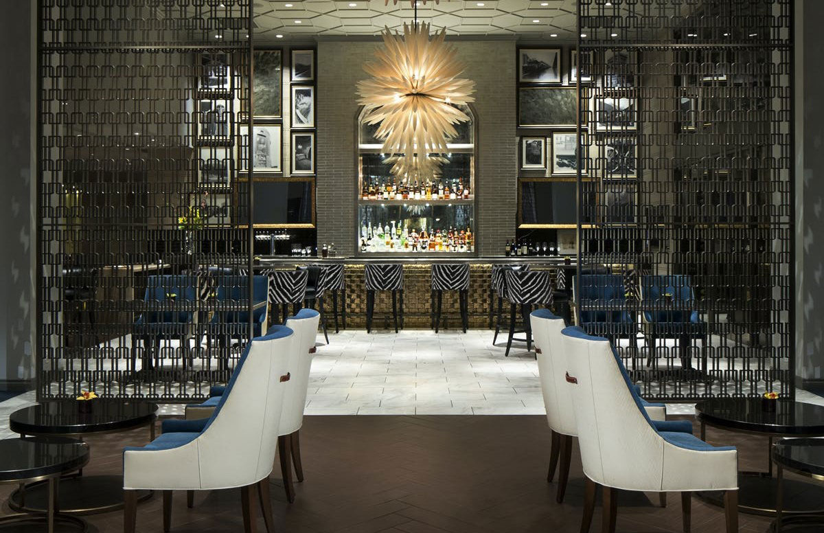 a room with a bar and chairs