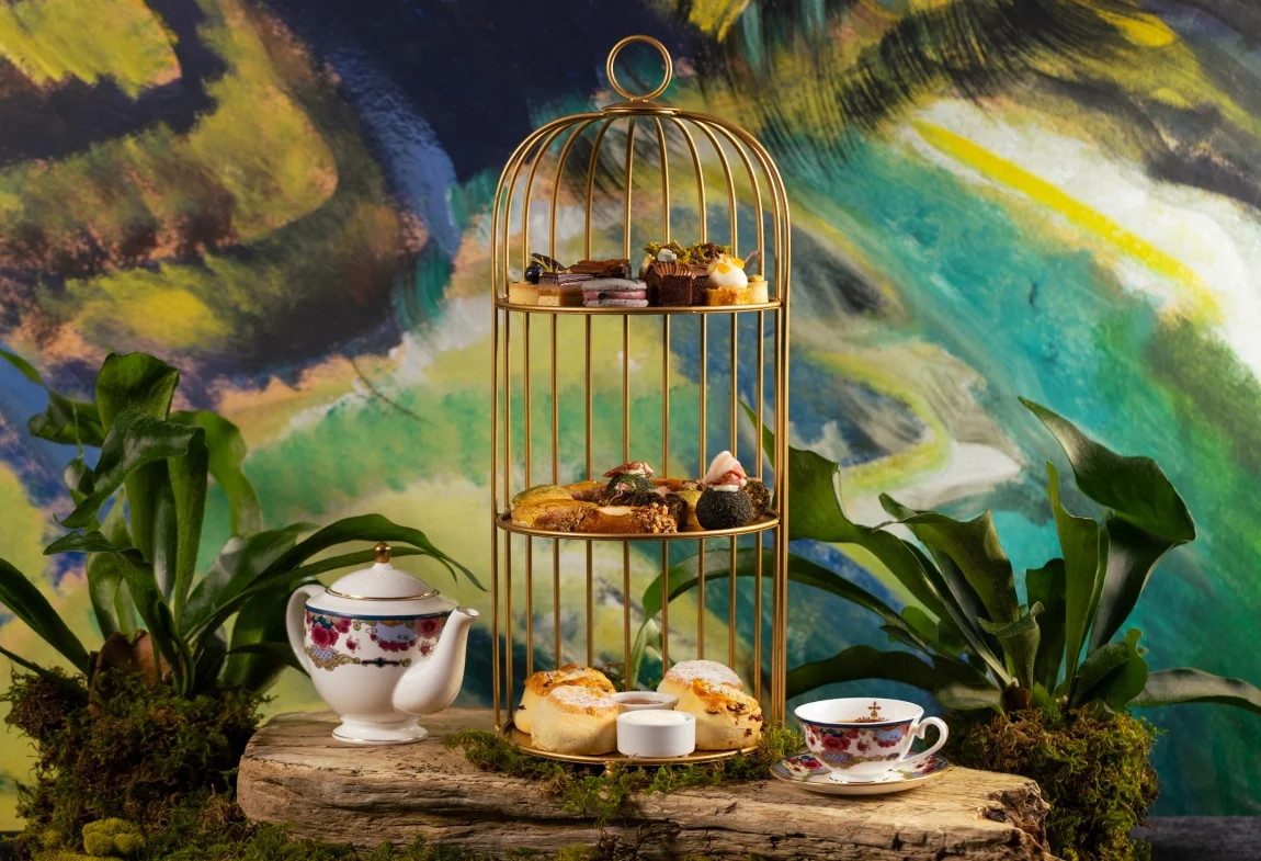 a gold bird cage with food on it