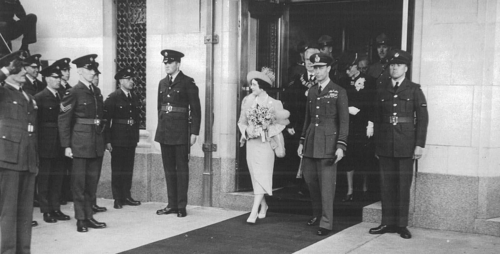 a woman in a dress walking out of a building