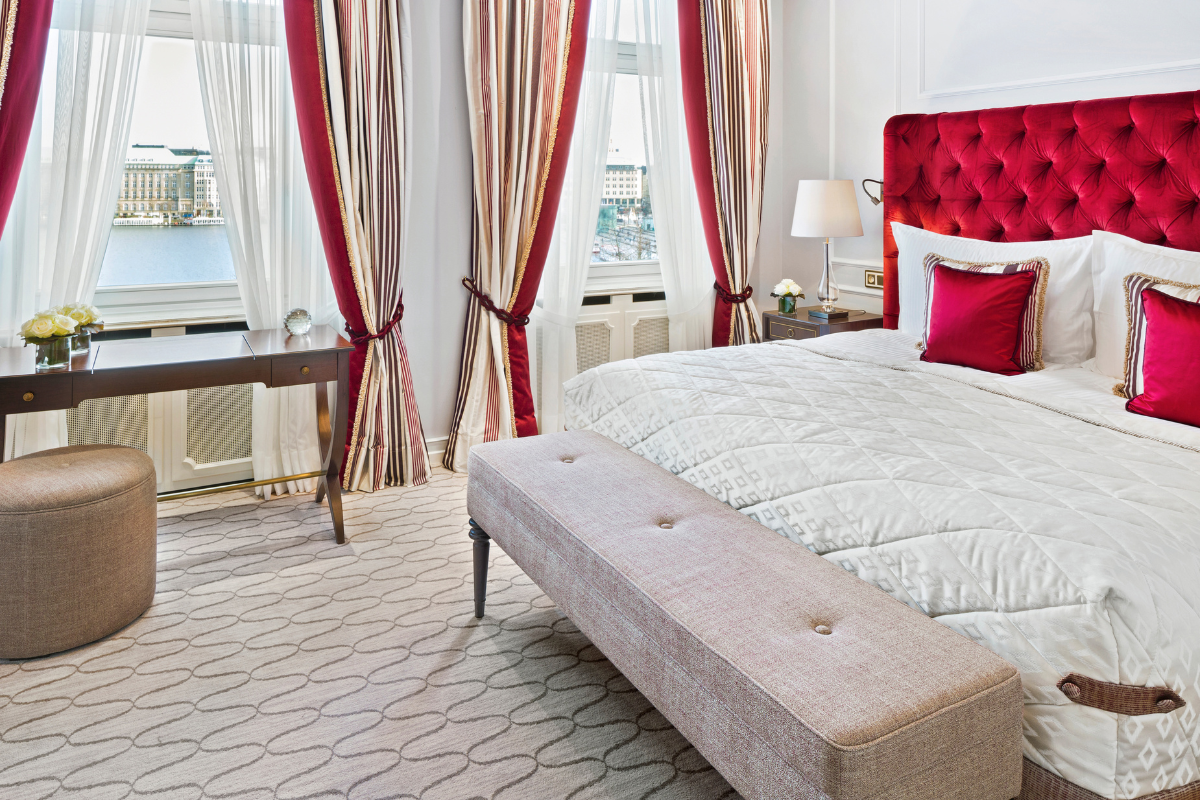 a bedroom with a bed and a bench