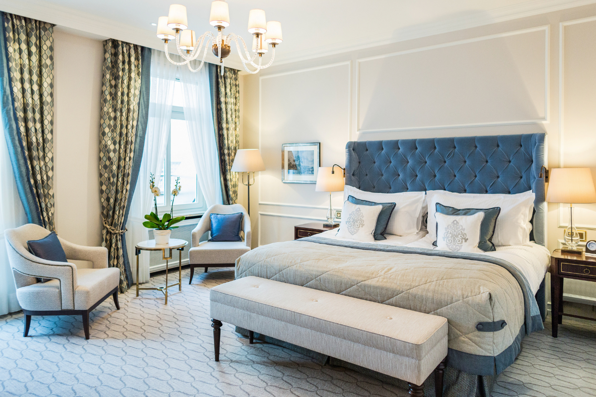 a bedroom with a bed and chairs