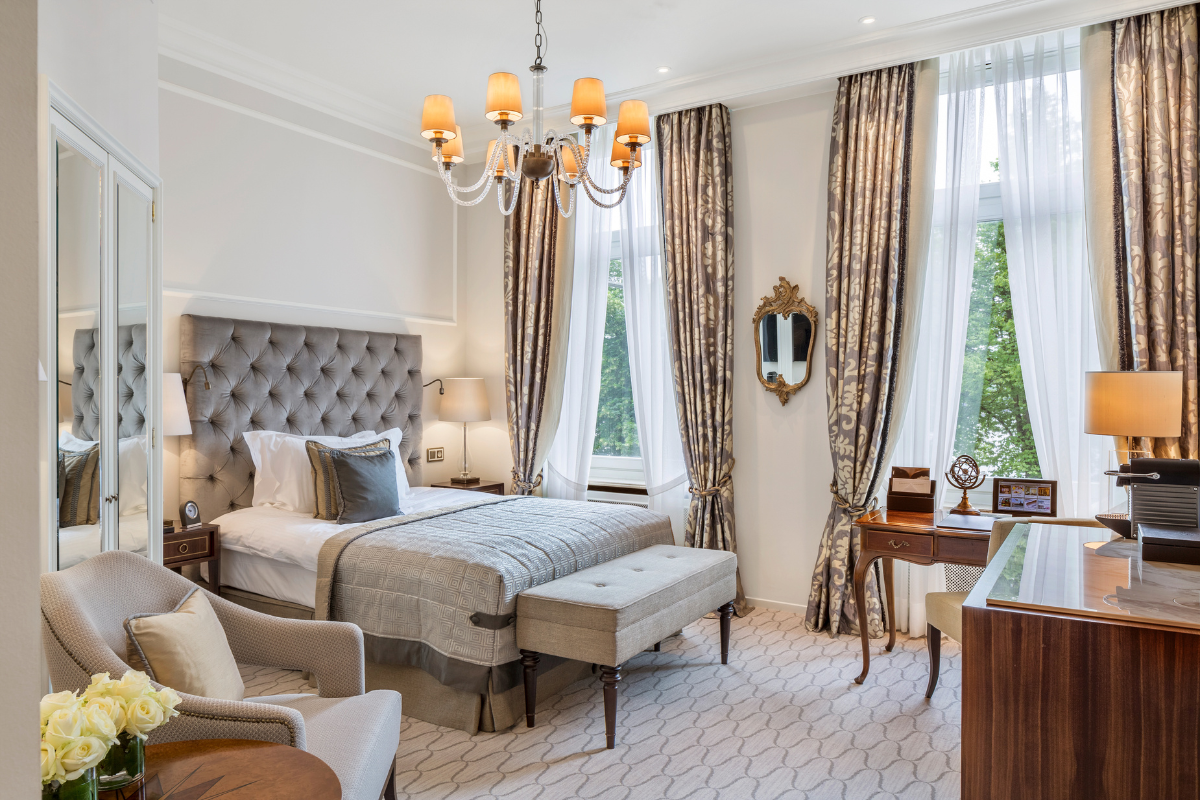 a bedroom with a bed and a chandelier