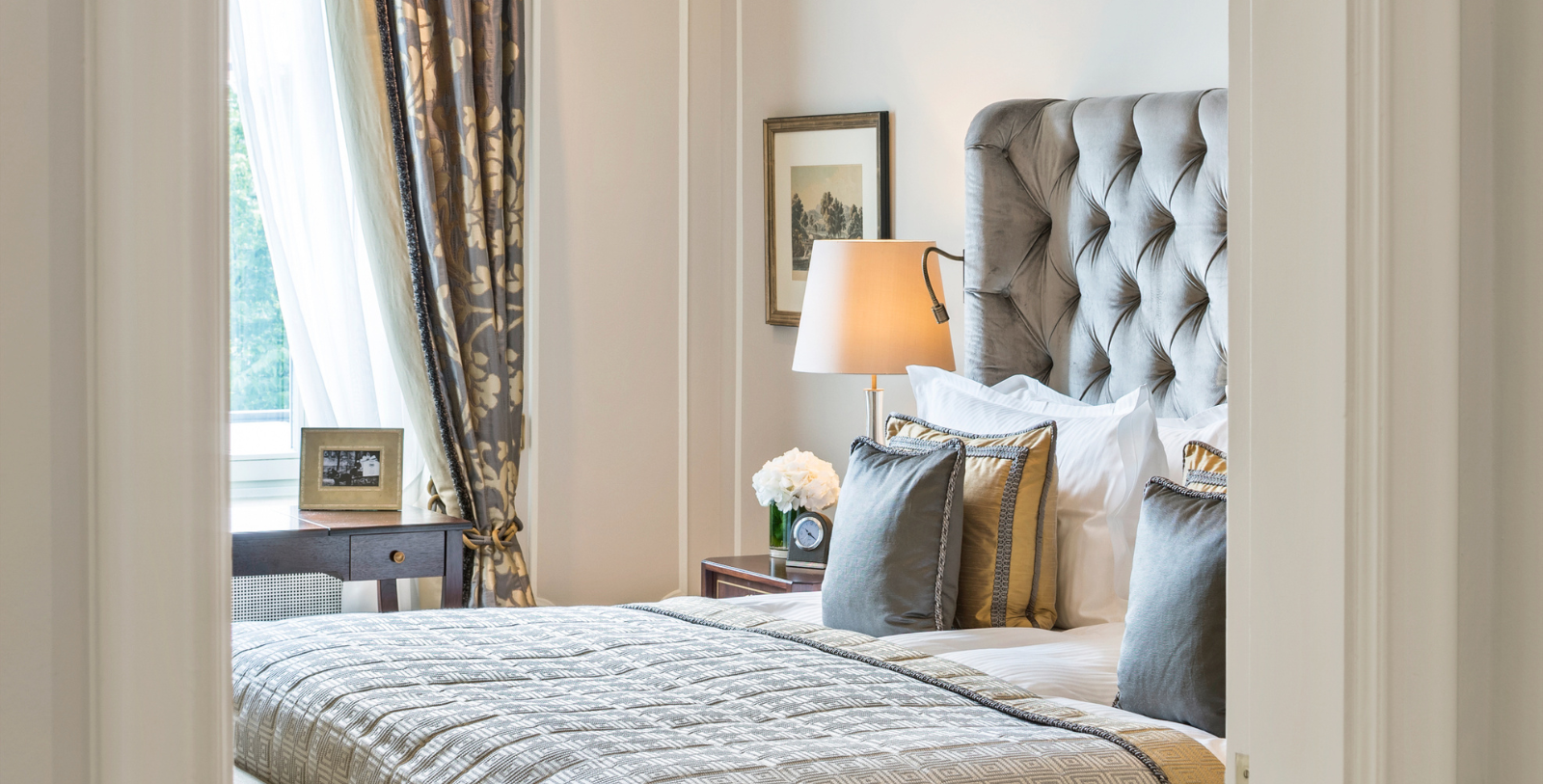a bed with pillows and a lamp