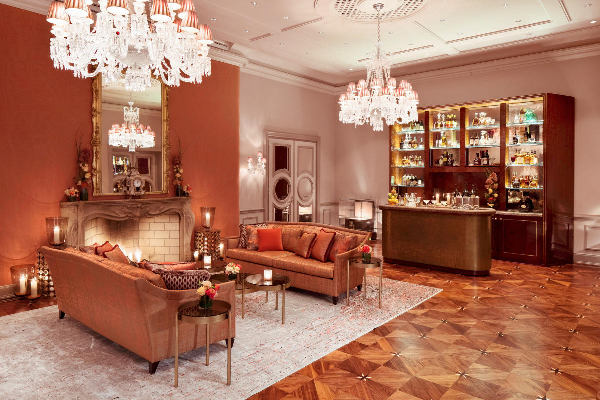 a room with a fireplace and chandeliers