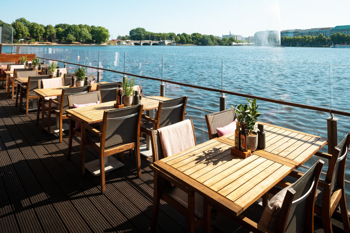 a table and chairs on a deck overlooking a body of water