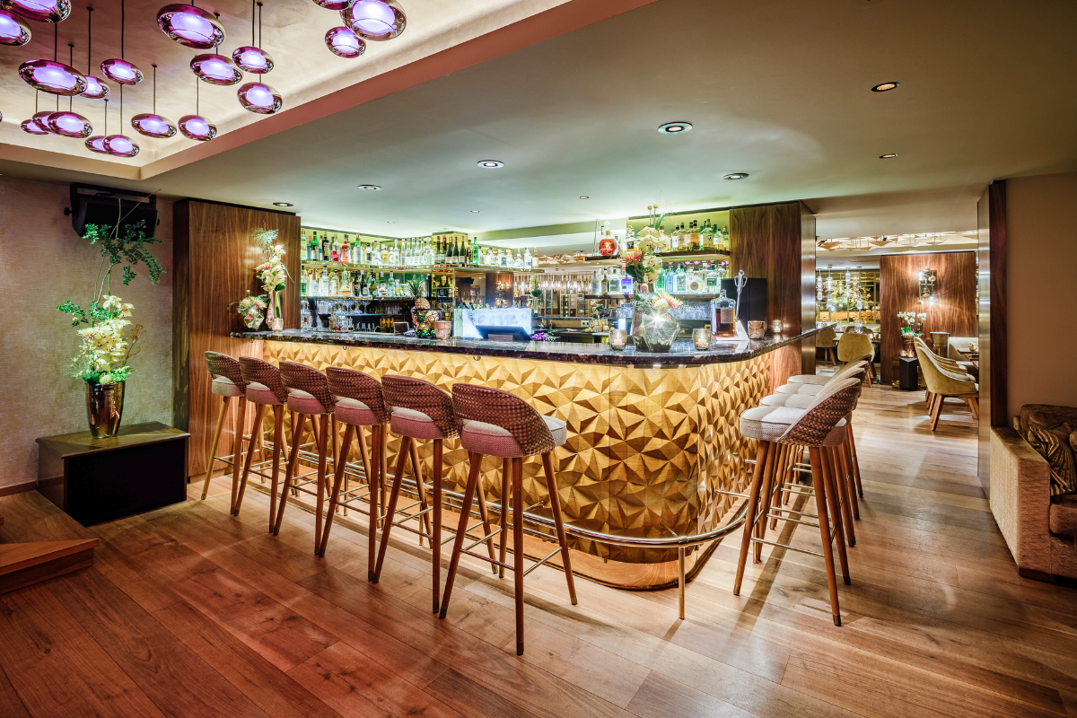 a bar with chairs and a counter