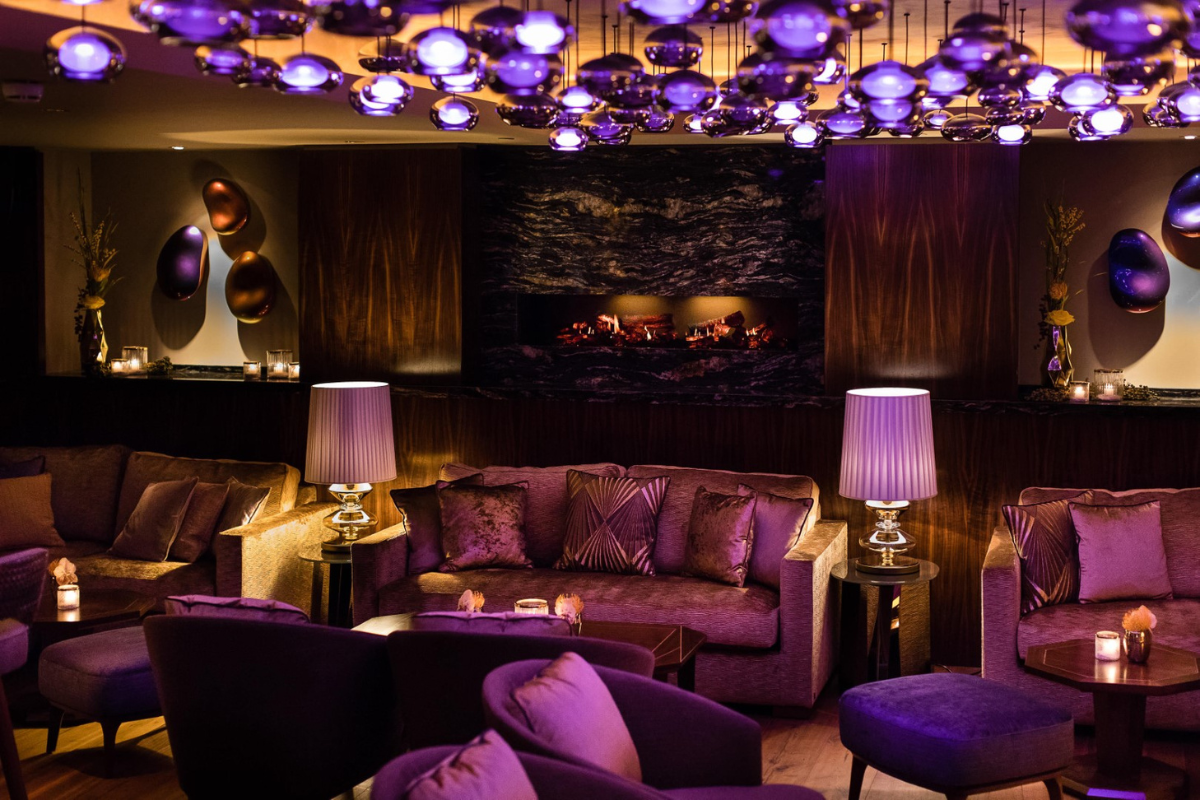 a room with purple furniture and a fireplace