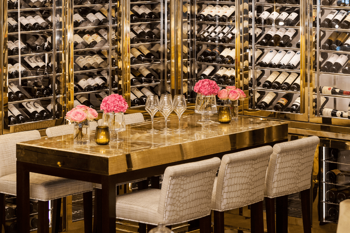 a wine cellar with wine bottles and wine glasses