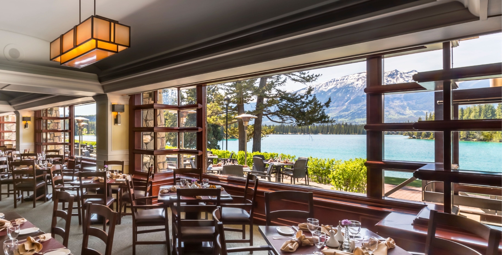 a room with a view of a lake and mountains