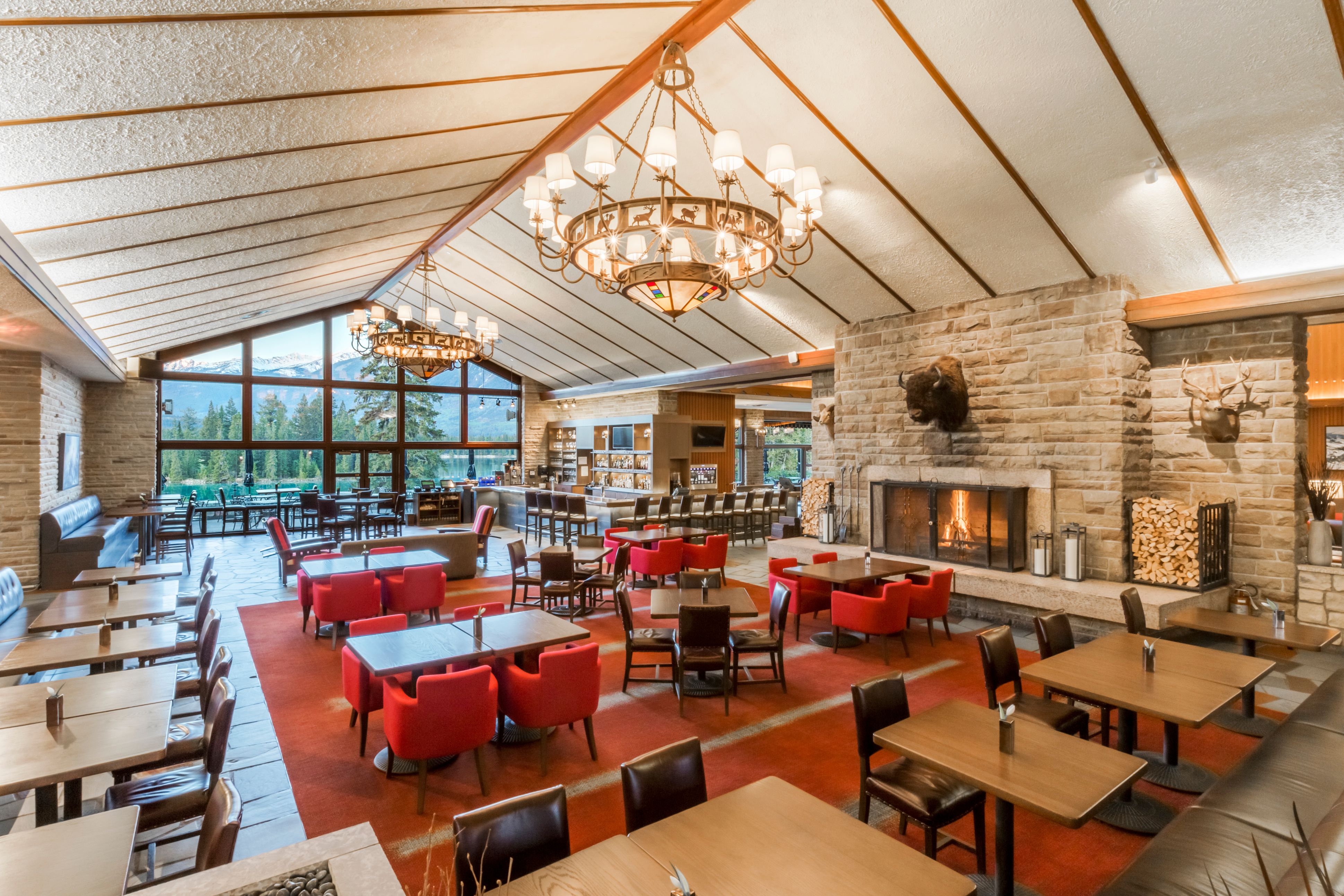 a room with tables and chairs and a fireplace
