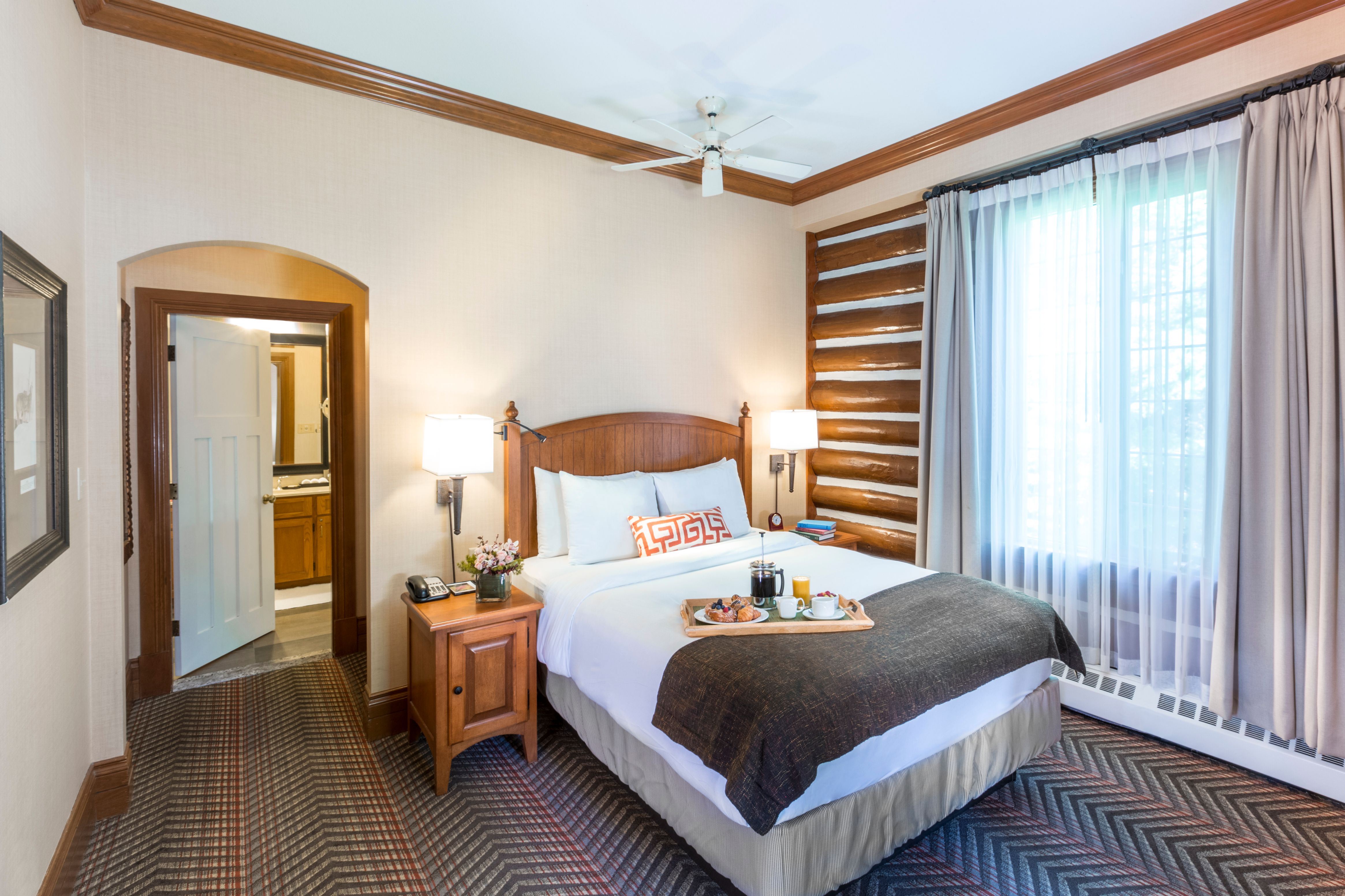 a bed with tray of food on it