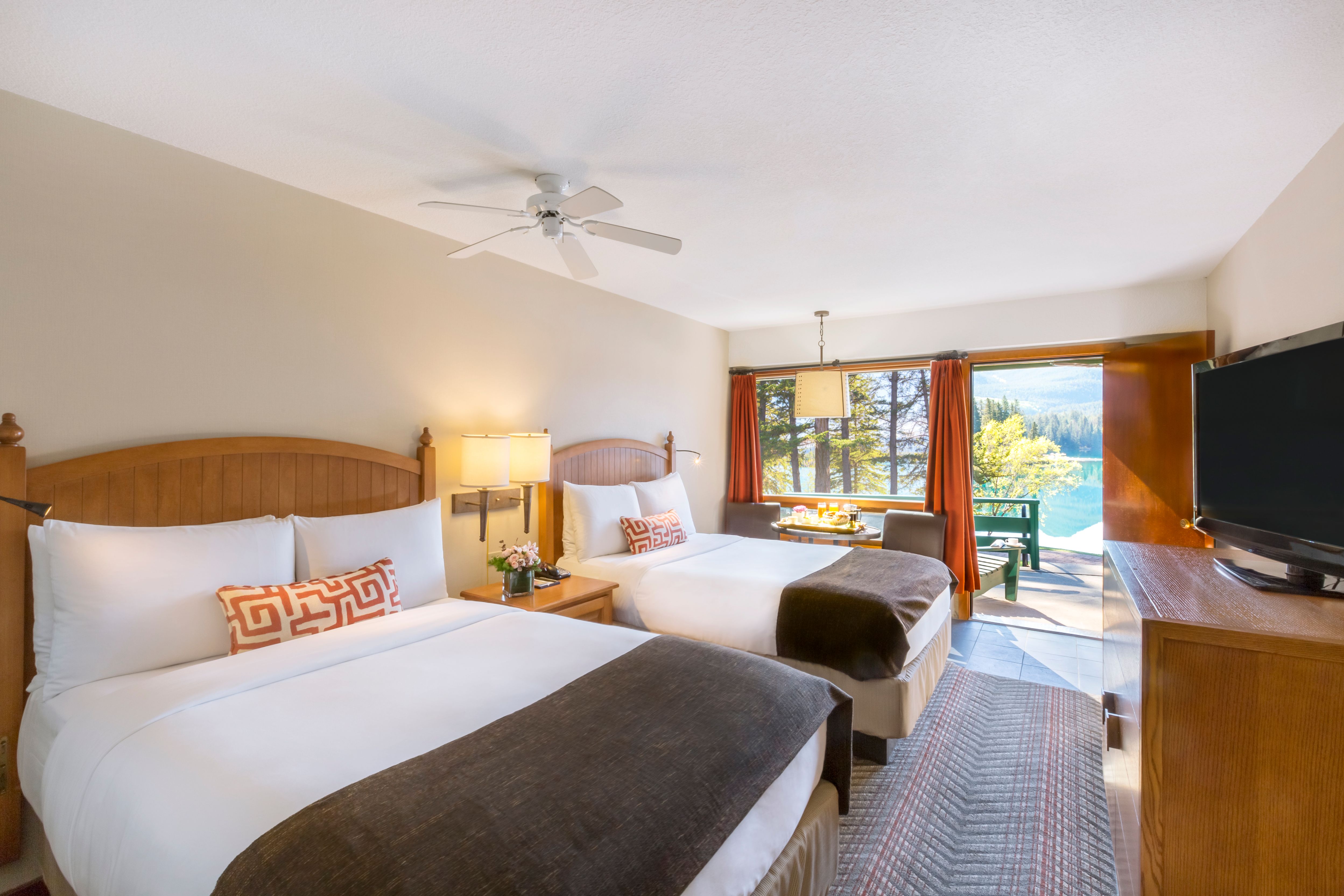 a room with two beds and a ceiling fan