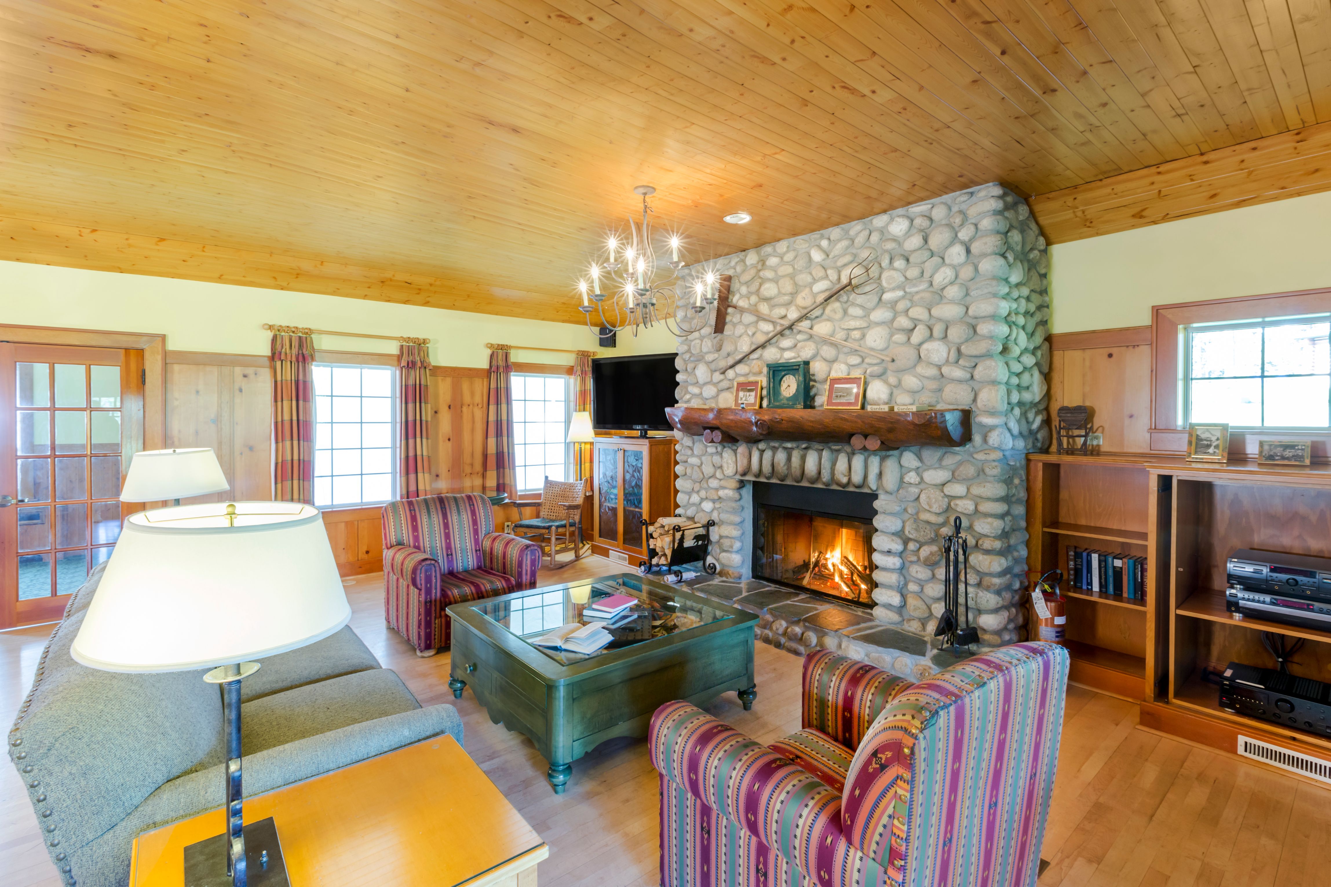 a living room with a fireplace and chairs