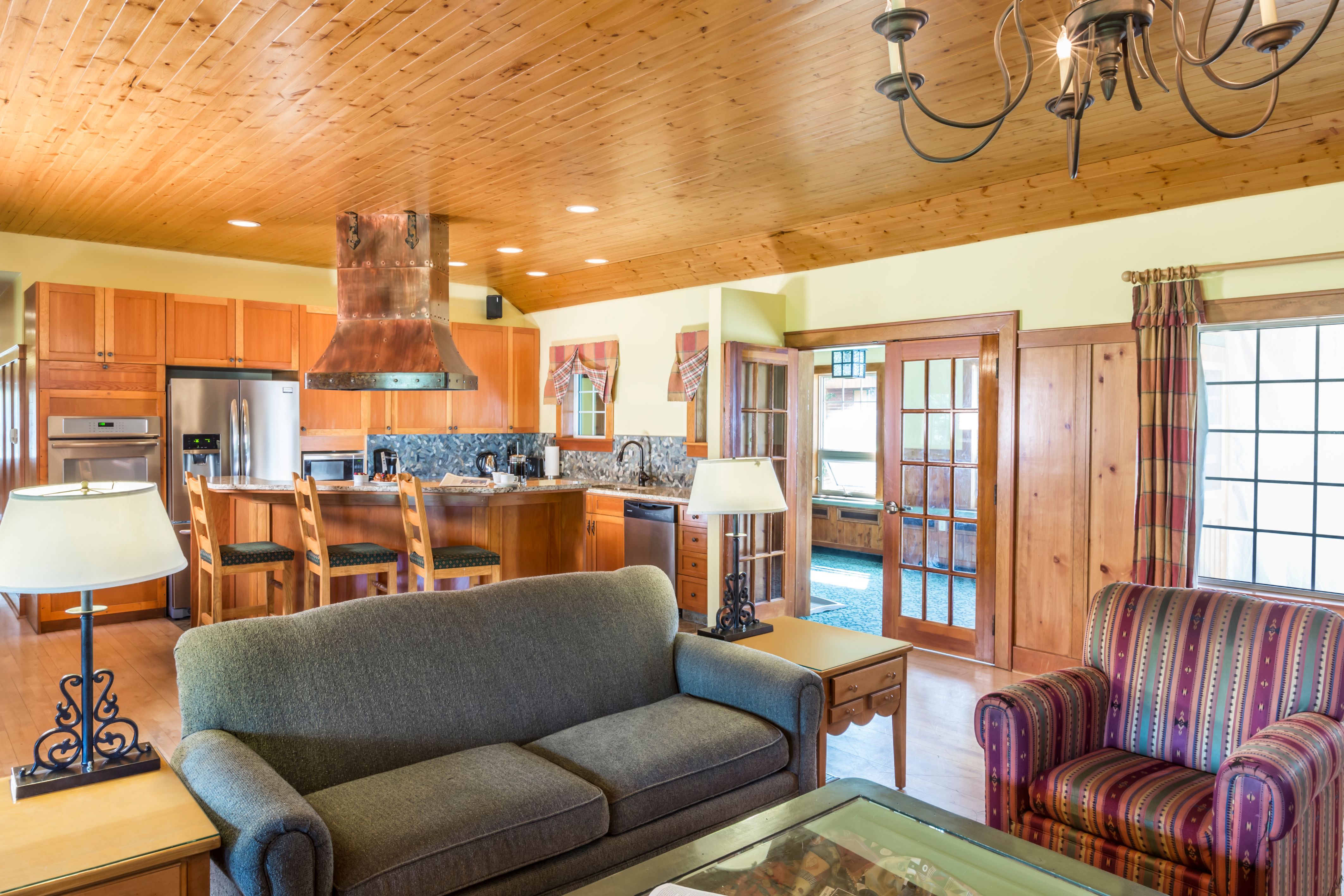 a living room with a couch and kitchen