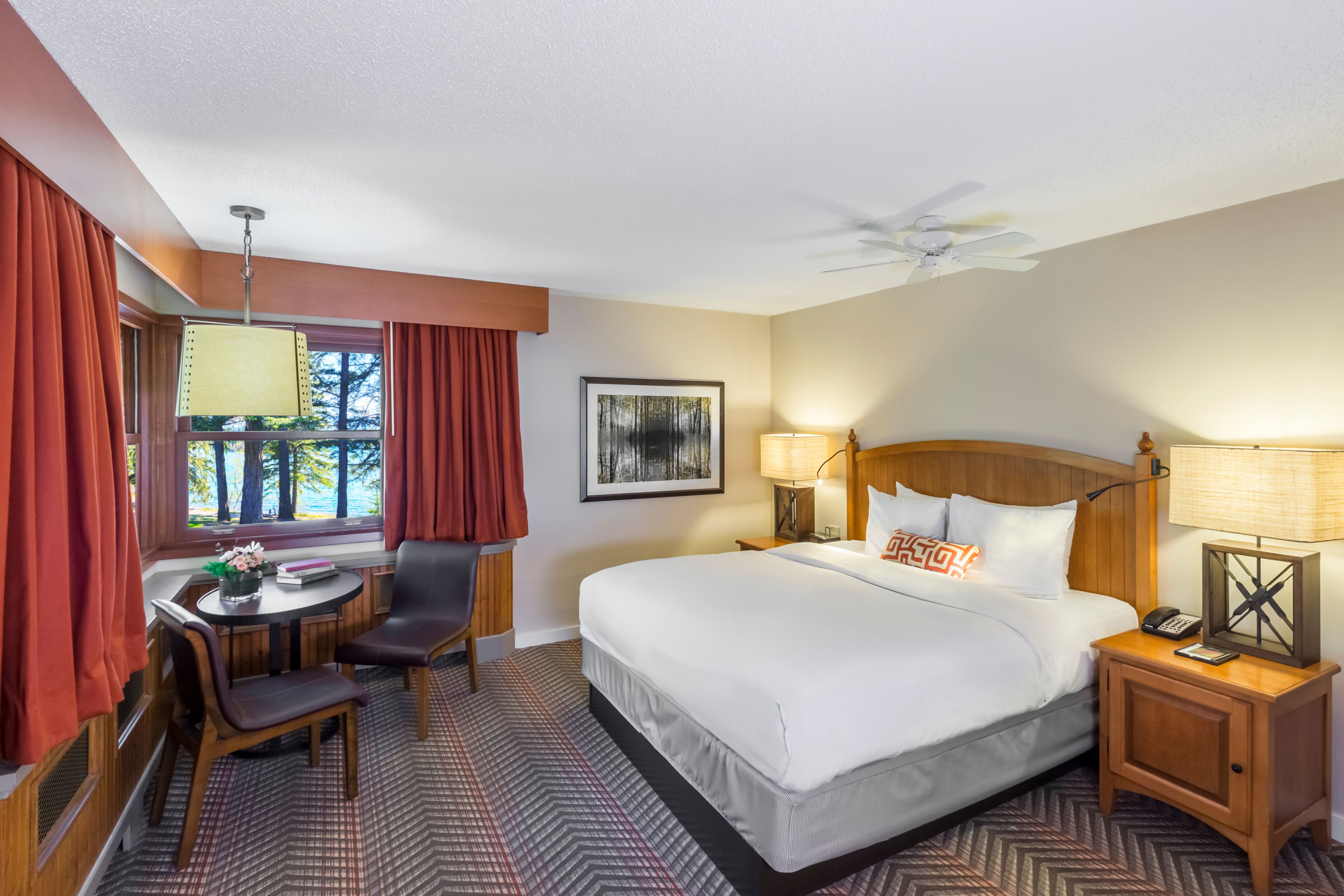 a room with a bed and a table and chairs