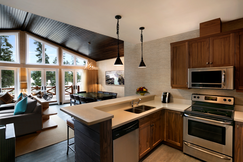 a kitchen with a large island and a dining area