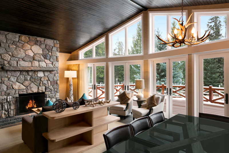 a living room with a stone fireplace and a stone fireplace