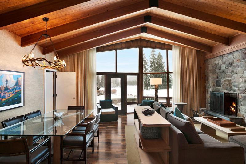 a room with a glass table and chairs