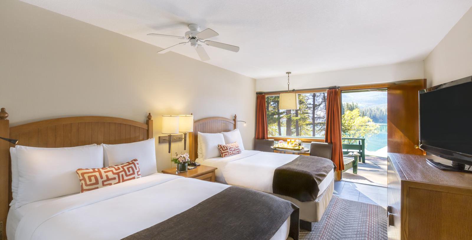 a room with two beds and a ceiling fan