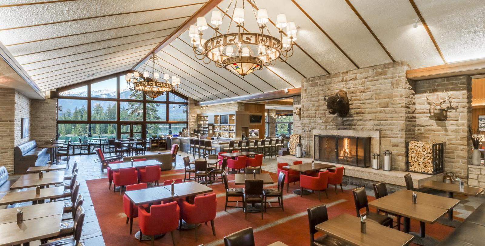 a room with tables and chairs and a fireplace
