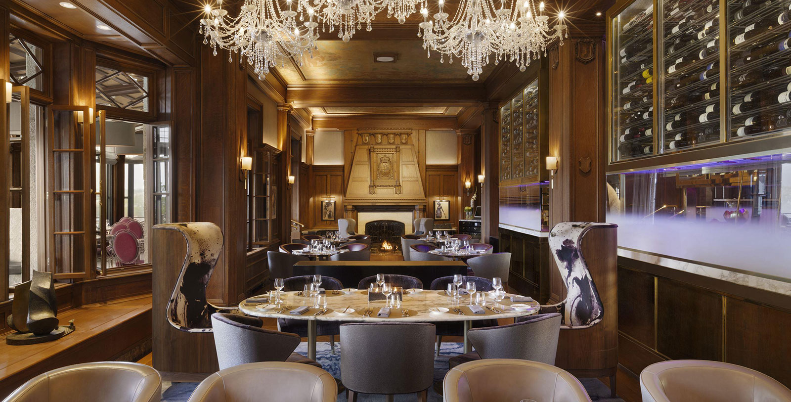 a room with a chandelier and tables