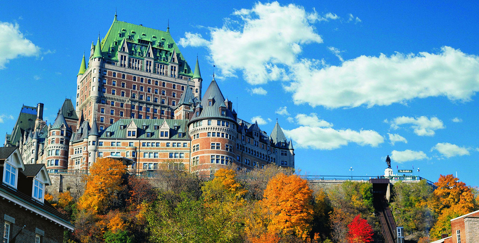 a large building with trees in the background with Château Frontenac in the background
