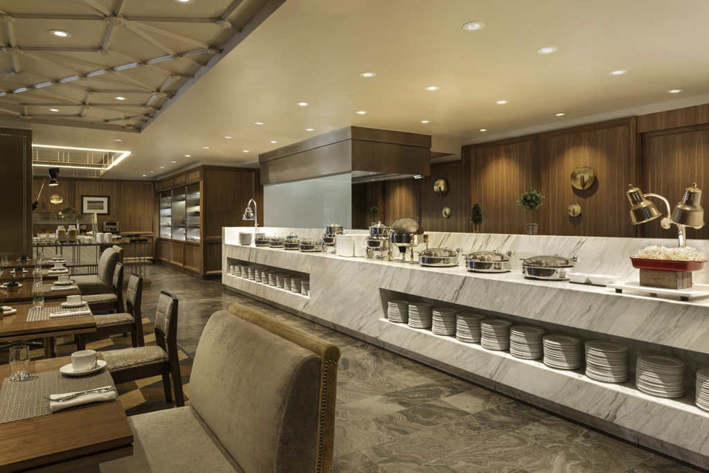 a buffet area with a counter and chairs