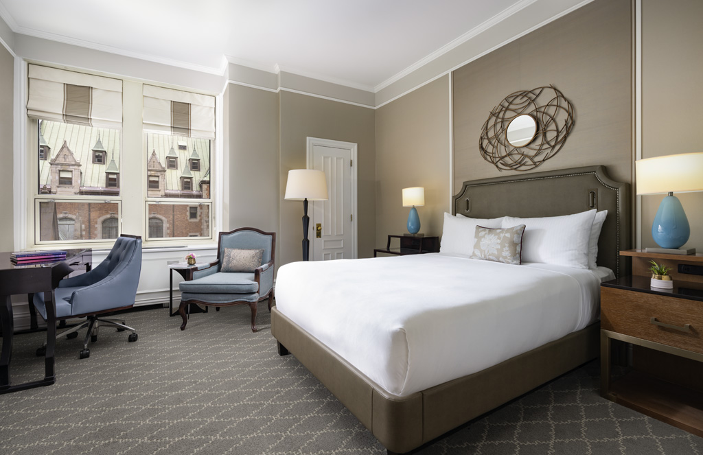 a bedroom with a bed and chair
