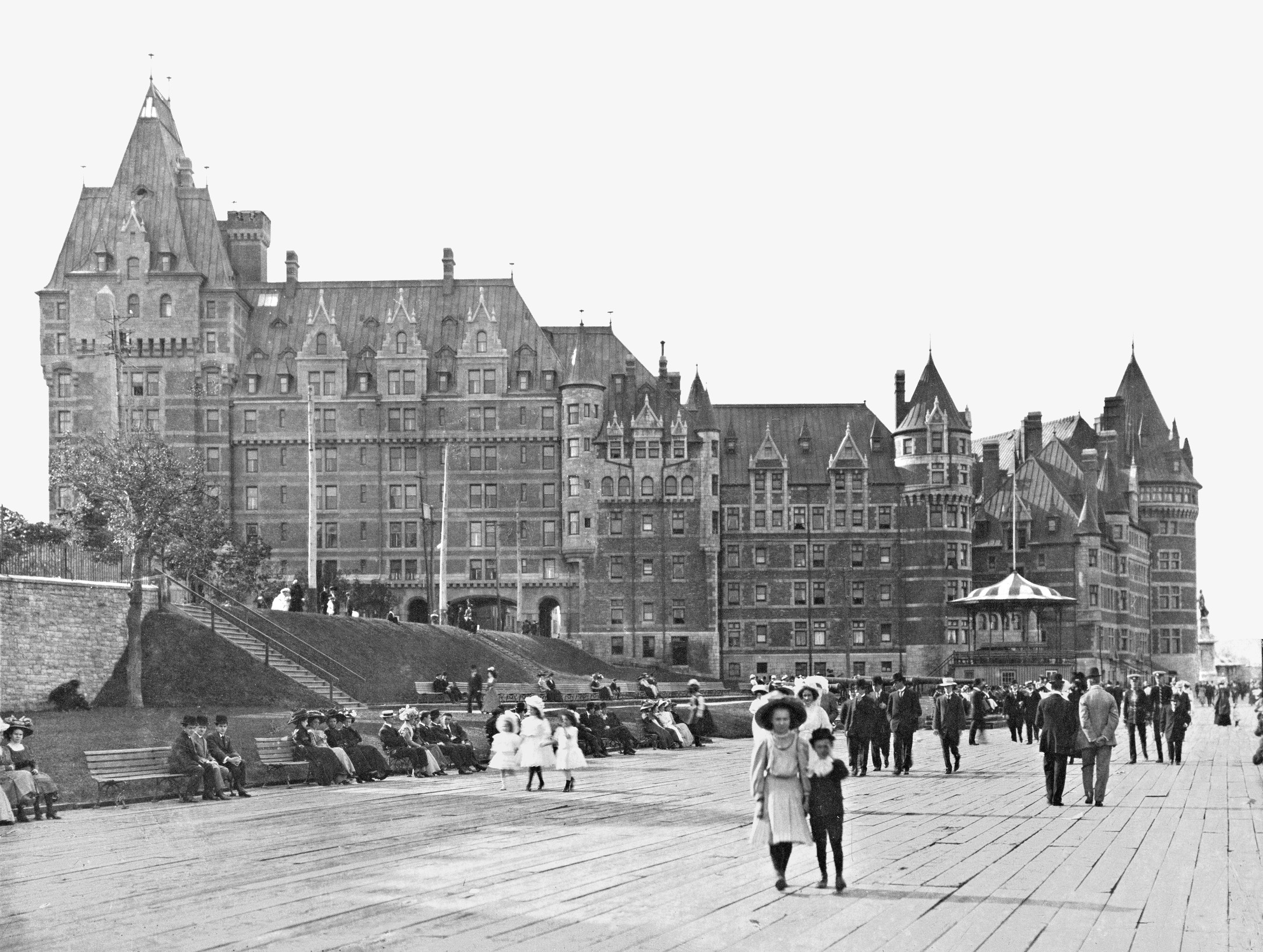 a group of people walking on a boardwalk