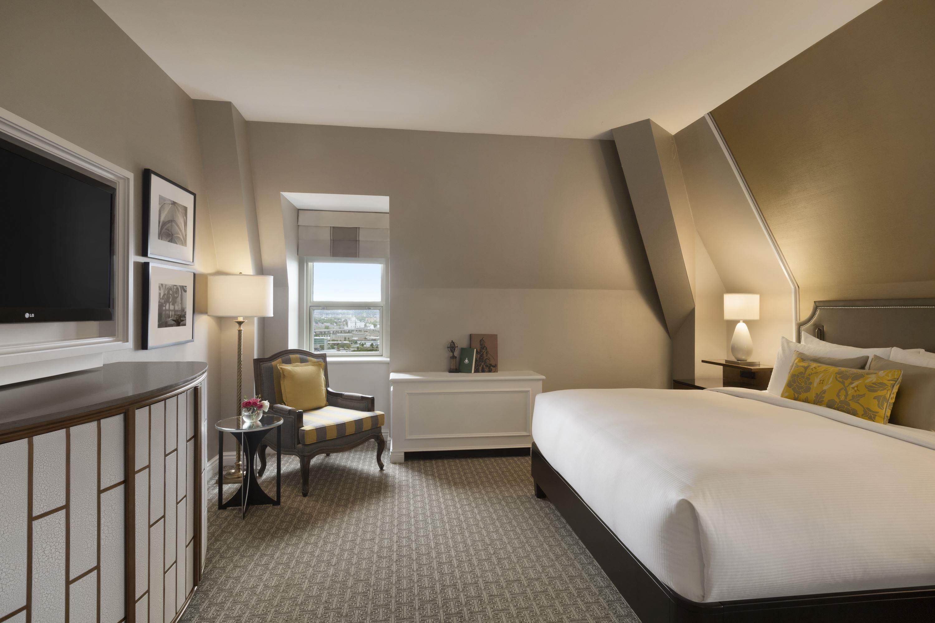 a bedroom with a bed and a chair
