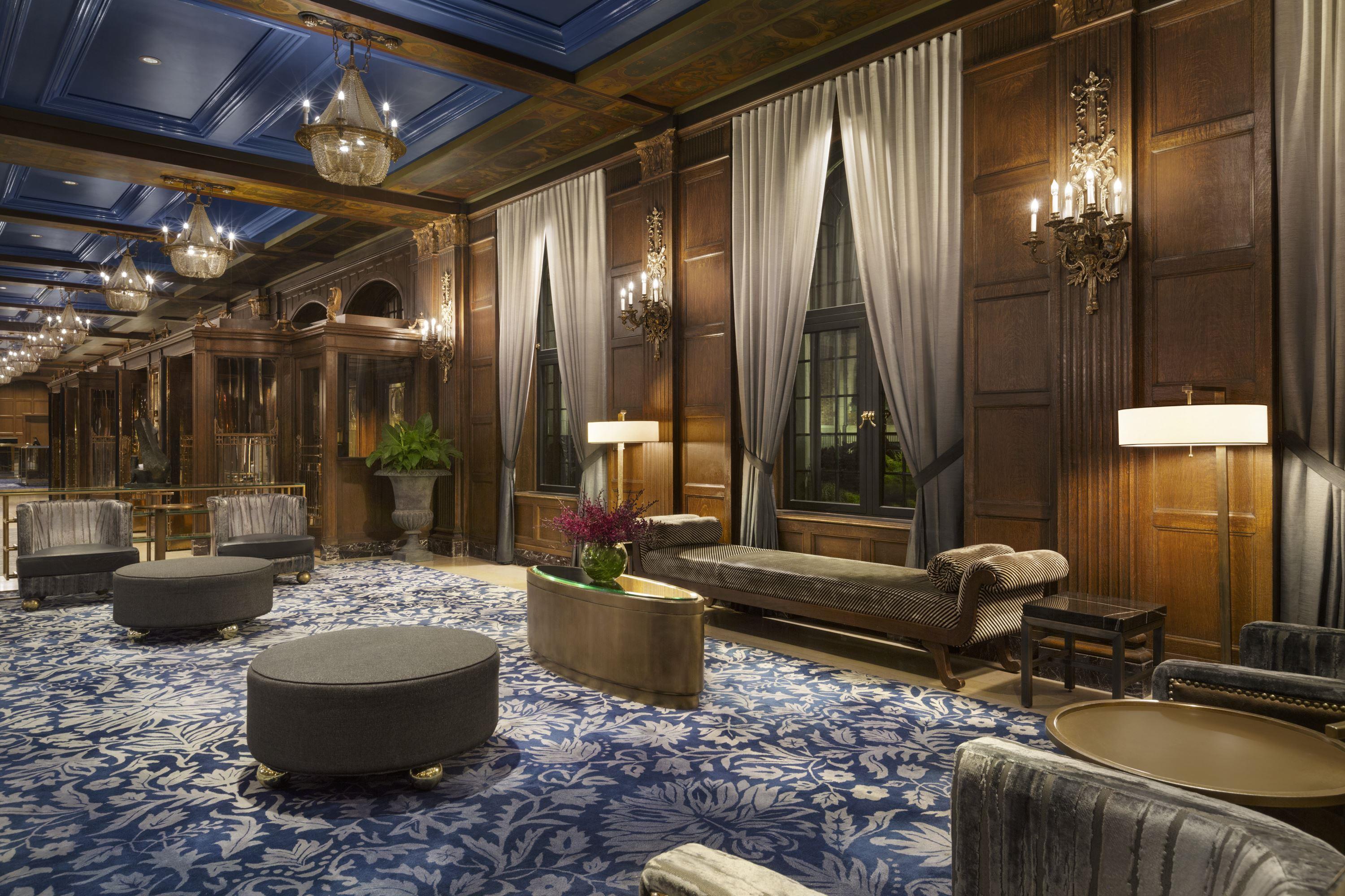 a room with a blue carpet and chandeliers