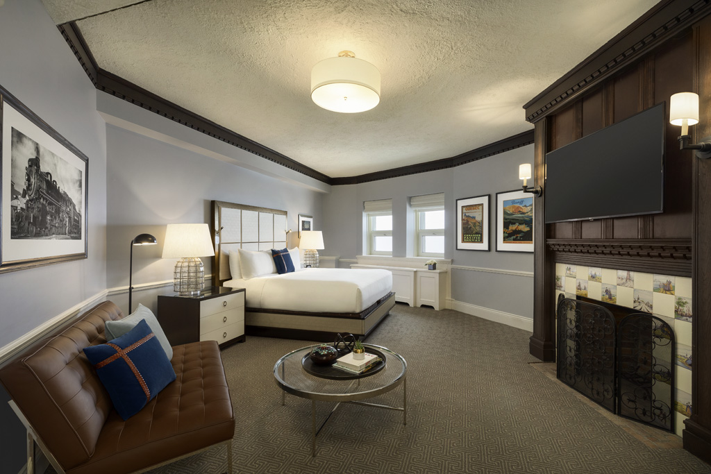 a room with a bed and a fireplace